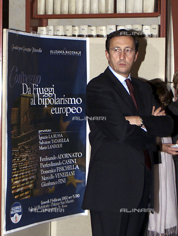AAE-S-000203-8MUL - The then Deputy Prime Minister Gianfranco Fini next to the poster of the conference of the National Alliance (AN) ''Da Fiuggi a bipolarismo europeo'' - Date of photography: 07/02/2002 - Maurizio Brambatti, 2002 / © ANSA / Alinari Archives