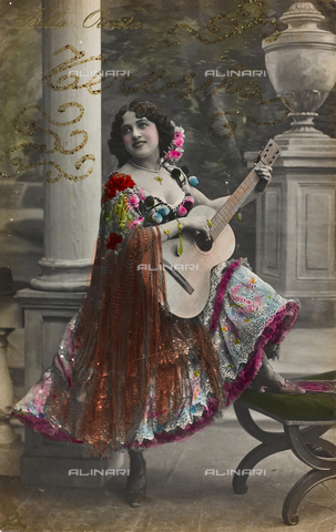 AVQ-A-000140-0141 - Postcard, portrait of a woman wearing traditional spanish costumes while playing guitar, "Album para Tarjetas postales" - Date of photography: 1910 ca. - Alinari Archives, Florence