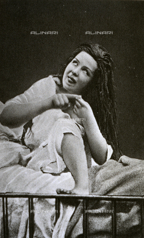 AVQ-A-000200-0028 - Young woman having a fit of convulsive hysteria. The patient is sitting on a bed in a clear state of excitement - Date of photography: 1878 - Verchi Marialieta Collection / Alinari Archives, Florence