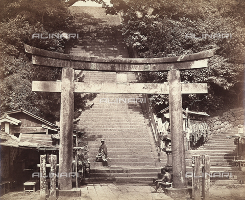 AVQ-A-000887-0028 - View of the hundred-step stairway at the entrance to Attango-yama or the Mount of the God Attango in Edo (ancient name of Tokyo). In the foreground, the Torii entrance door. On the stairway, a samurai. A local is seated on the base of a column of the Torii door. - Date of photography: 1863-1877 - Alinari Archives, Florence