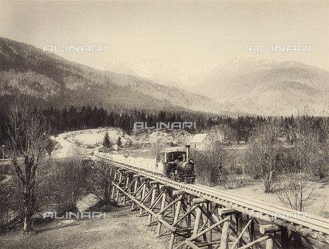 AVQ-A-001321-0024 - Construction of Worcheiner Tunnels, begun in 1897. The tunnel connected the general plan to Trieste. The image shows the transportation of material on rails over a wooden bridge. The album was commissioned by the Friulian entrepreneur Giacomo Ceconi from Montececon - Date of photography: 1905 ca. - Alinari Archives, Florence
