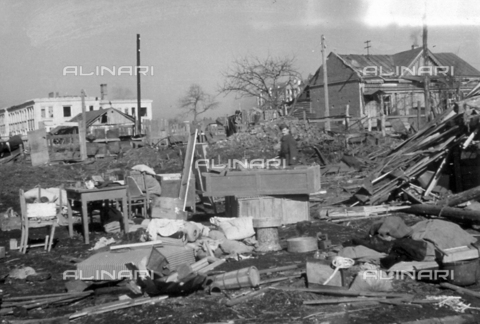 AVQ-A-001479-0079 - An Italian soldier looks at furniture and various other furnishings piled up, in the outskirts of a town in White Russia - Date of photography: 02-03/1943 - Alinari Archives, Florence