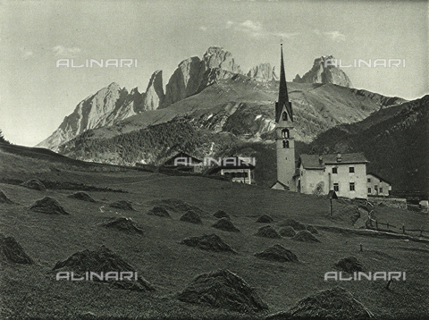 AVQ-A-001889-0022 - The church of Alba near Canazei with the Sassolungo mountain chain in the background - Date of photography: 1925-1930 ca. - Alinari Archives, Florence