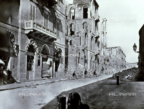 AVQ-A-002695-0008 - Via delle Poste Italiane in Alexandria, Egypt, filled with rubble after being shelled by the English Army. At the center of the picture a few men are posing in front of a partially destroyed building. In the foreground, on the left, a seriously damaged French Bank - Date of photography: 1882 - Alinari Archives, Florence