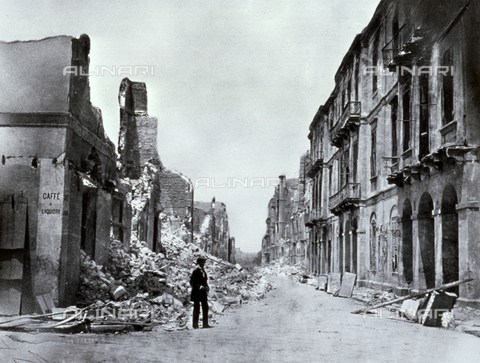 AVQ-A-002695-0020 - A street in Alexandria, Egypt, seriously damaged by the shelling of 1882. In the foreground, a man is posing in front of the ruins of the Italian Post Office - Date of photography: 1882 - Alinari Archives, Florence