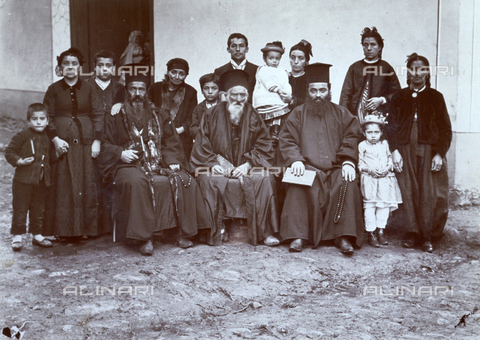 AVQ-A-003089-0012 - Three Orthodox-Christian priests in religious attire shown seated, surrounded by a group of men, women and children in traditional Turkish dress - Date of photography: 1890 ca. - Alinari Archives, Florence