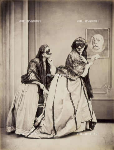 AVQ-A-003142-0006 - Genre scene set in the Eighteenth century. Two young women, their faces covered by masks, are furtively going down the corridor of a building, holding a note - Date of photography: 1880 ca. - Alinari Archives, Florence