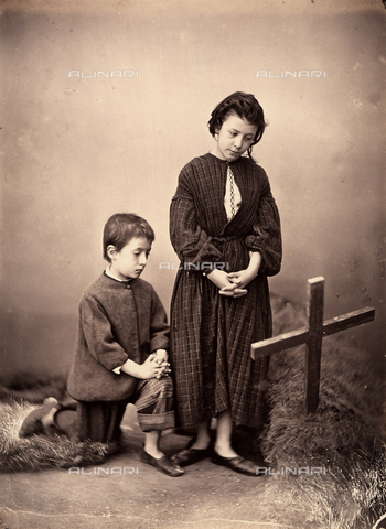 AVQ-A-003142-0008 - "Orfanelli". Genre scene created in a Nineteenth century studio. Two poor orphans in humble attire are sorrowfully praying on the tomb of their parents - Date of photography: 1870-1880 ca. - Alinari Archives, Florence