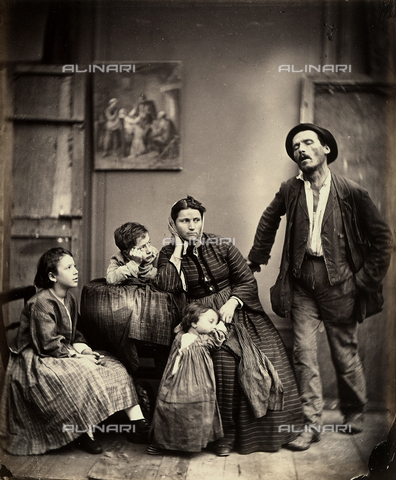 AVQ-A-003142-0011 - "La miseria". Genre scene set in a lowly home. At the center of the picture a young melancholy woman is seated with her children around her. Her husband is at her side - Date of photography: 1870-1880 ca. - Alinari Archives, Florence