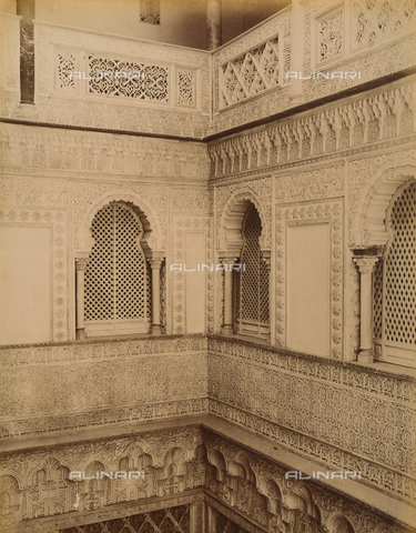AVQ-A-003897-0014 - Corner view of the patio of las Muà±ecas in the Alcazar, Seville. The patio, dating back to the Caliphs of Cordoba, is an example of Mudéjar decoration with azulejos (colored tiles) and stucco Arabesques - Date of photography: 1880 - 1890 - Alinari Archives, Florence