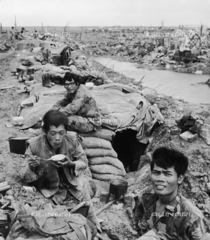 EVA-S-001009-7404 - Vietnam War: three Vietnamese soldiers photographed in the destroyed city of Quang Tri during a Viet Cong attack - Date of photography: 09/1972 - Hubertus  Kanus / © Mary Evans / Alinari Archives