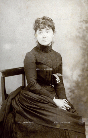 FBQ-F-000038-0000 - Three-quarter length portrait of a young woman in elegant late nineteenth century dress. She is posing in the studio, seated on a chair - Date of photography: 1885 - Alinari Archives, Florence