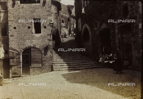 FBQ-F-001205-0000 - A characteristic small square in Subiaco, with humble stone houses. In the background, a staircase with houses on either side - Date of photography: 1882 -1887 ca. - Alinari Archives, Florence