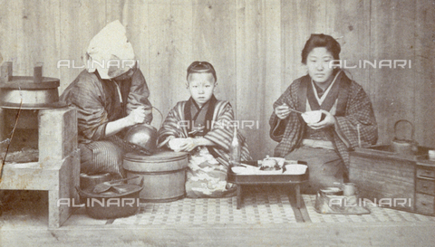 FBQ-S-001734-0003 - Scene showing a Japanese family, composed of father, mother and son, in a domestic setting, during a meal - Date of photography: 1870 ca. - Alinari Archives, Florence