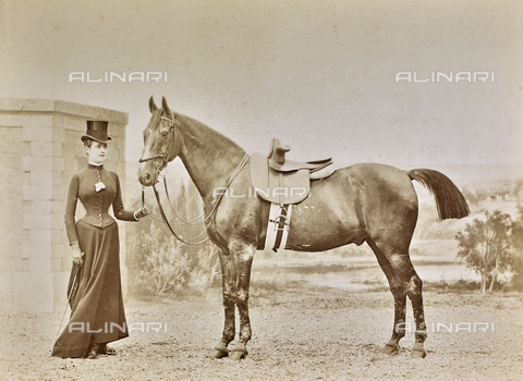 FCC-F-012895-0000 - Portrait of a young woman in horse riding clothing with a horse. - Date of photography: 1900 ca. - Alinari Archives, Florence