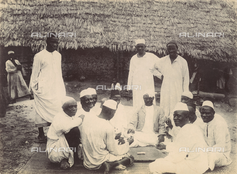 FVQ-F-030629-0000 - Group of men playing cards in a village on the island of Zanzibar - Date of photography: 1900 ca. - Alinari Archives, Florence