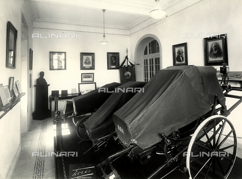GCQ-F-009178-0000 - Funerary wagons in a room of the Emergency Unit museum in Alexandria, Egypt. Building constructed by Ernesto Verrucci - Date of photography: 1935 ca. - Alinari Archives, Florence