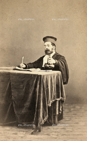 GRQ-F-004207-0000 - Portrait of the lawyer Torbolini, judge of Leghorn, seated at a desk and wearing his judge's robe and hat - Date of photography: 1875 - 1890 ca. - Alinari Archives, Florence