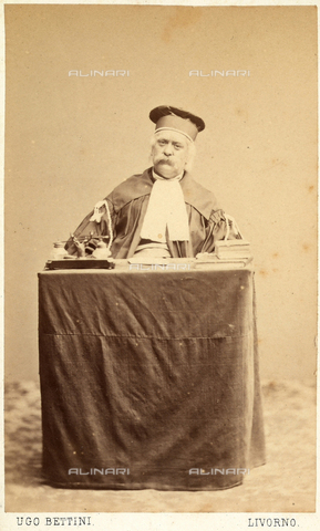 GRQ-F-004210-0000 - Portrait of a man wearing the robes of a judge, seated at a table filled with courtroom equipment - Date of photography: 1875 ca. - Alinari Archives, Florence