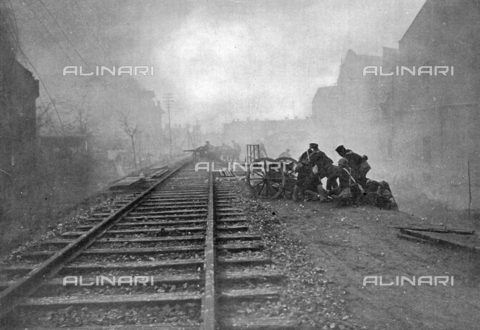 IIB-S-093210-0305 - Japanese sailors, positioned between the tracks of the Shanghai train station, attempt to conquer the valuable strategic point - Date of photography: 02/1932 - Alinari Archives, Florence