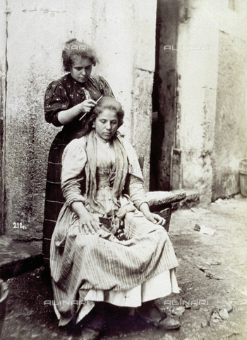 MFC-A-004650-0004 - Young woman shown having her long hair dressed by a hairdresser - Date of photography: 1890 ca. - Alinari Archives, Florence