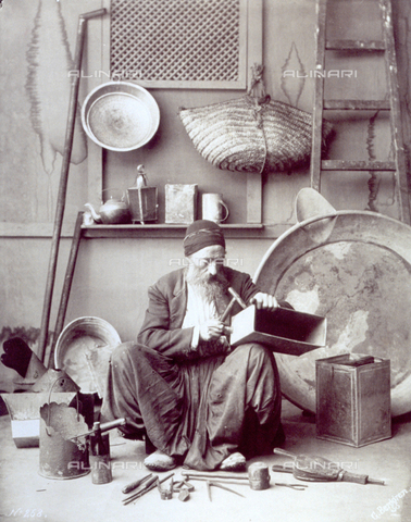 MFC-F-000331-0000 - Craftsman at work, surrounded by handcrafted metal objects and by tools - Date of photography: 1879-1881 - Alinari Archives, Florence