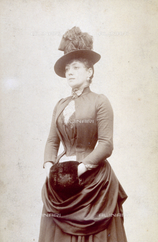 MFC-F-001056-0000 - Three-quarter-length portrait of young woman in elegant clothes, with small plumed hat and muff - Date of photography: 1880 ca. - Alinari Archives, Florence