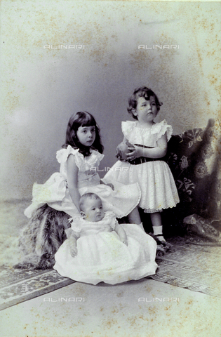 MFC-F-001494-0000 - Portrait of three little girls of whom one is only a few months old. They are posing seated on the floor on furs and rugs. One of them holds a ball - Date of photography: 1890-1900 ca. - Alinari Archives, Florence