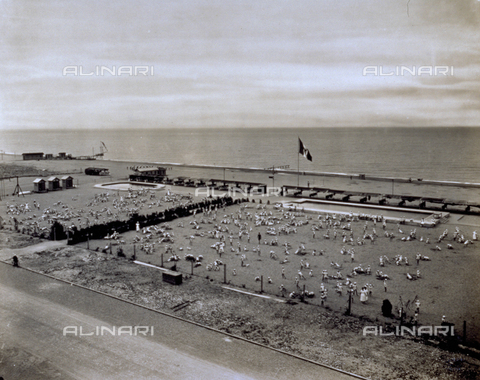 MFC-F-001722-0000 - View from above of a beach where the members of a summer camp are playing games. In the background two swimming pools, cabins and tents - Date of photography: 1930 ca. - Alinari Archives, Florence
