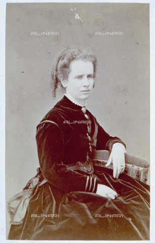 MFC-F-001905-0000 - Three-quarter length portrait of a young lady. She is seated and wearing a velvet dress with her hair gathered at the nape of her neck - Date of photography: 1865-1871 ca. - Alinari Archives, Florence