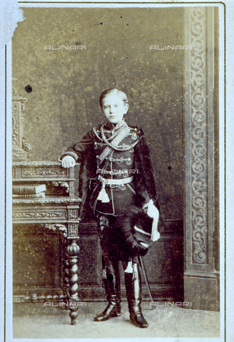 MFC-F-002344-0000 - Full-length portrait of an adolescent in uniform, probably the small czar of Russia. He is leaning on a table with books - Date of photography: 1860-1870 ca. - Alinari Archives, Florence