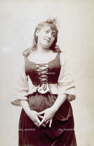 MFC-S-001057-0003 - Three-quarter-length portrait of young woman in traditional clothes. She is wearing a peasant dress and her hands are joined lying on her lap - Date of photography: 1880 ca. - Alinari Archives, Florence