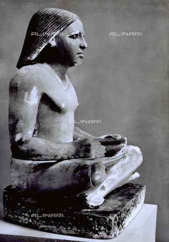 MFC-S-001350-0004 - Egyptian statue of a scribe reading a papyrus. The statue dating to 2700 b.c., is in the Egyptian Museum of Cairo - Date of photography: 1958 - Alinari Archives, Florence
