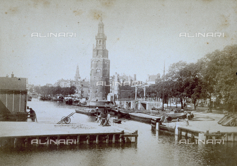 MFC-S-002191-0008 - A canal in Amsterdam with piers for tying up boats and barges. In the background Montalbaanstoren, one of the two towers, still standing, of the fortified walls of Amsterdam - Date of photography: 1865-1875 ca. - Alinari Archives, Florence