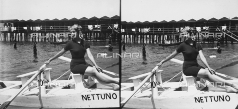 PCA-F-000013-0000 - Stereoscopic view of a young woman posing on a paddle boat in Bagno Nettuno - Date of photography: 1914 ca. - Alinari Archives, Florence
