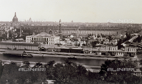 PDC-F-000254-0000 - In the background, beyond the seine, the expo palace and a few pavilions of the fair in Paris. In the foreground, dense foliage of trees in a garden - Date of photography: 1867-1867 - Alinari Archives, Florence