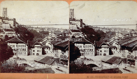 PDC-F-000423-0000 - View from above of Freiburg with the typical houses with large sloping roofs. A square with fountain, in the distance the large Suspension Bridge and the tower of the Gothic Cathedral of St. Nicholas - Date of photography: 1865-1875 ca. - Alinari Archives, Florence