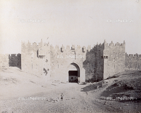 PDC-S-000275-0017 - The Damascus gate in Jerusalem, with a male figure posing - Date of photography: 1860-1870 ca. - Alinari Archives, Florence