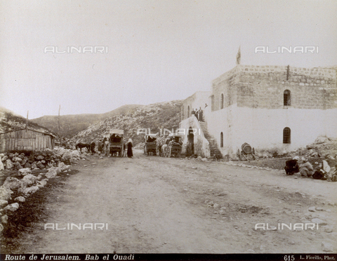 PDC-S-000752-0006 - Middle eastern travellers with carts and horses on the road for Jerusalem. A poor house stands along the road where there are some people sitting - Date of photography: 1880-1900 - Alinari Archives, Florence