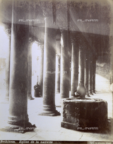 PDC-S-000752-0014 - Interior of the 'Church of the Nativity' in Bethlehem, with two long lines of columns, the font in the foreground and two friars - Date of photography: 1880-1900 - Alinari Archives, Florence