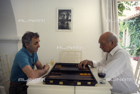 RVA-S-054342-0023 - Il produttore francese Eddie Barclay e il cantautore Charles Aznavour fotografati mentre giocano a backgammon a Saint-Tropez - Data dello scatto: 1988 - Jean-Régis Roustan / Roger-Viollet/Alinari